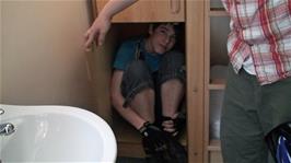 Zac demonstrates that he can almost fit in one of the storage cupboards in our room at Bath Youth Hostel